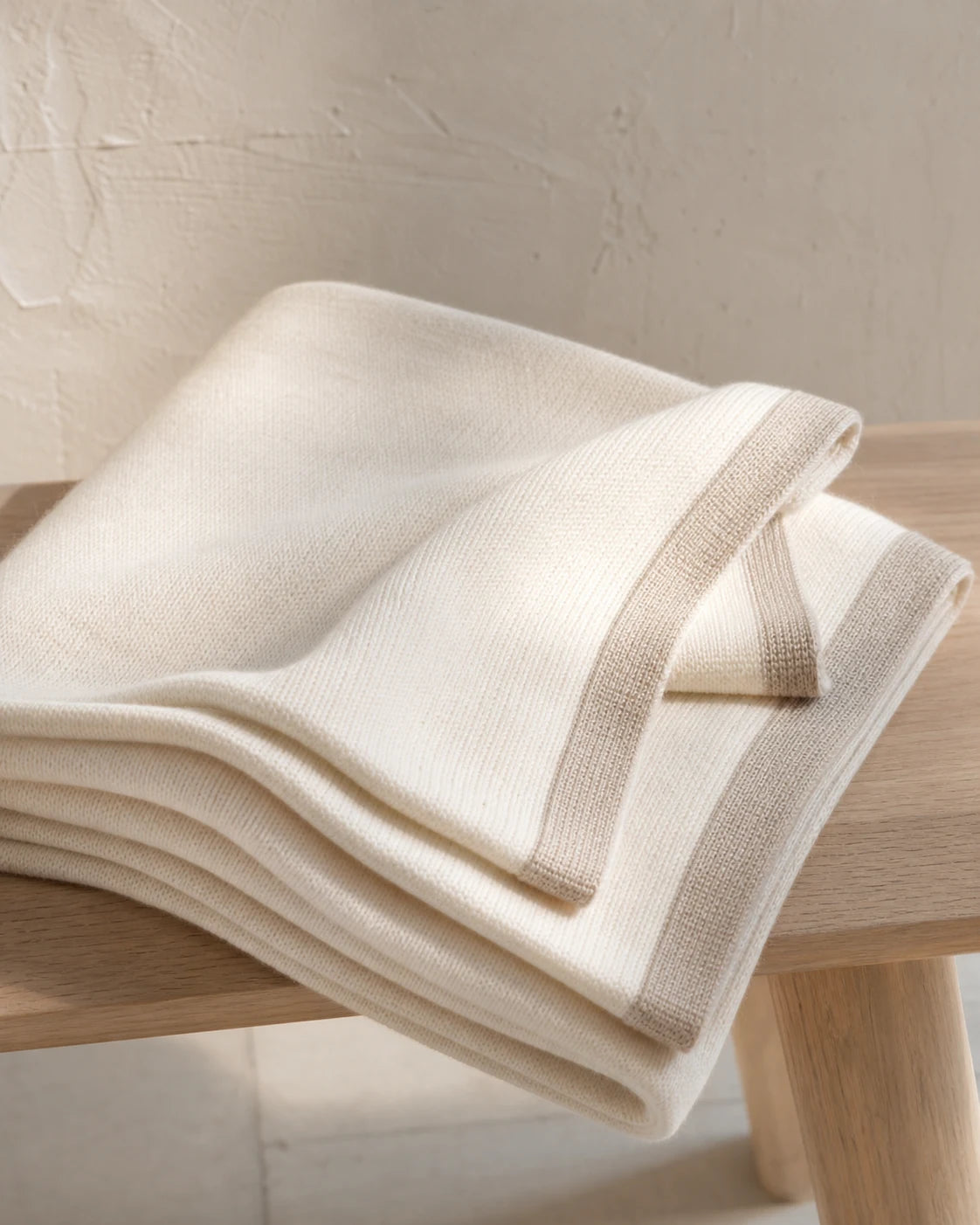 Warm ivory pram-sized cashmere baby blanket with oatmeal border