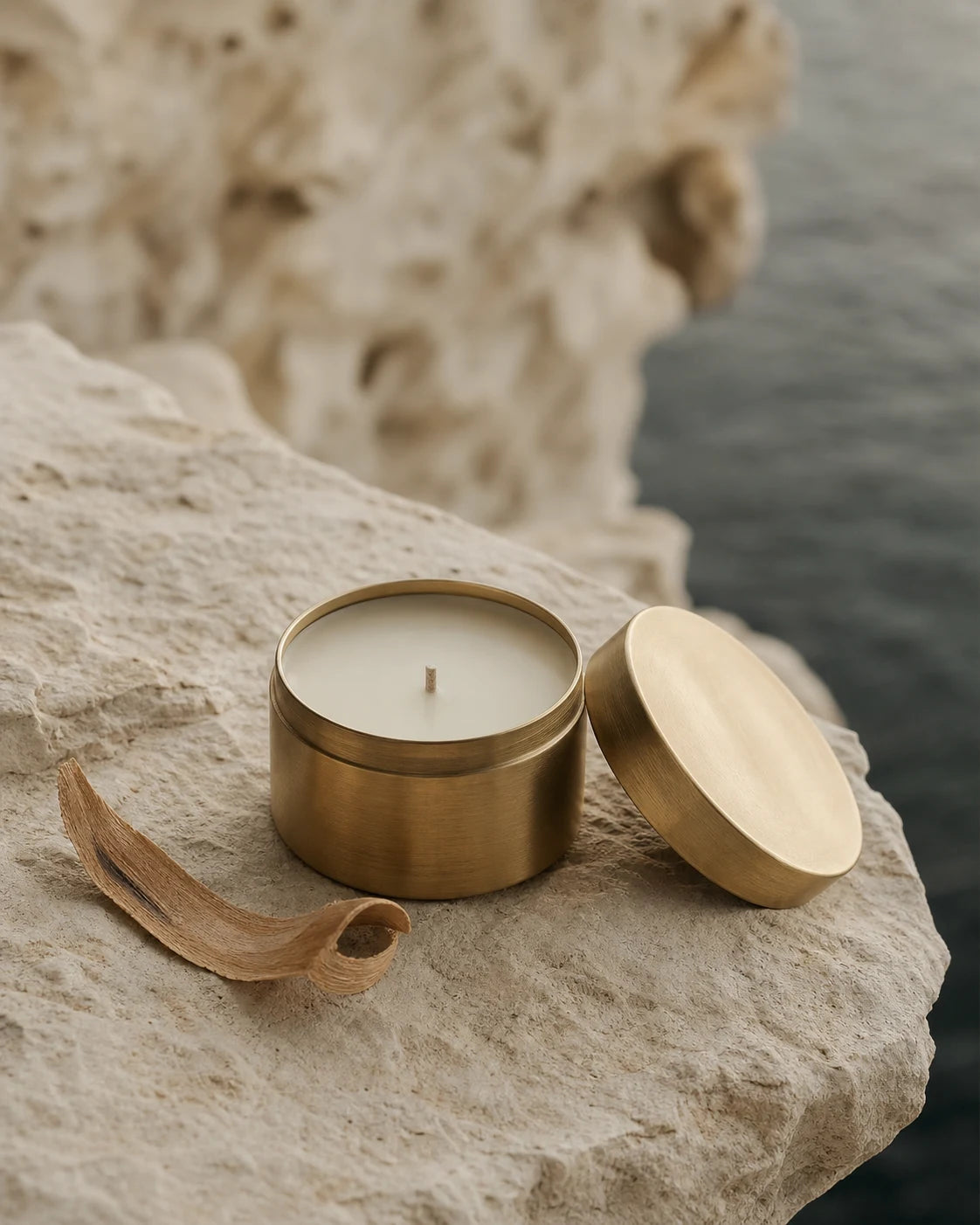Small cedar travel candle in a brushed brass lidded tin